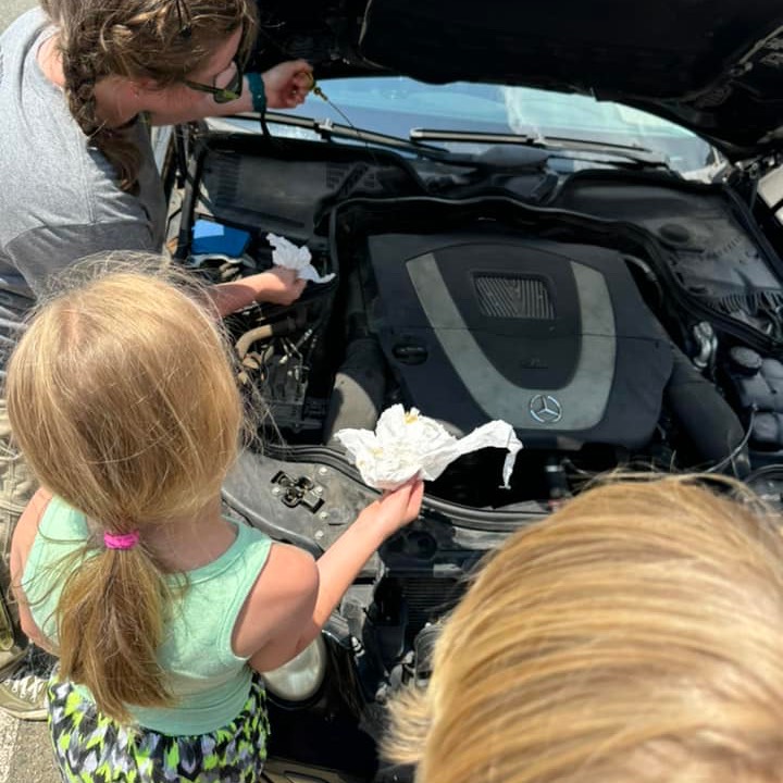 youth learning to change oil